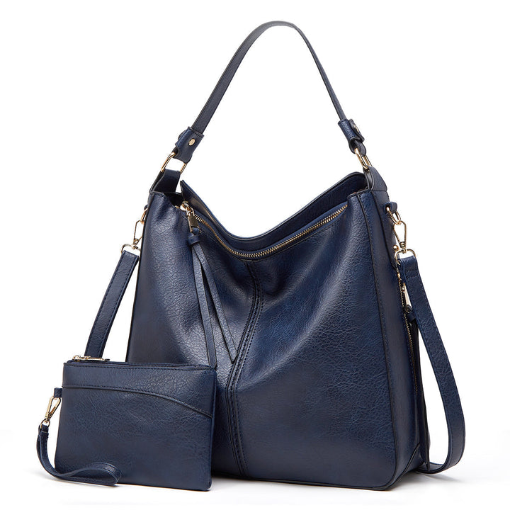 Modern women's leather shoulder bag with elegant gold details, suitable for both work and casual wear.