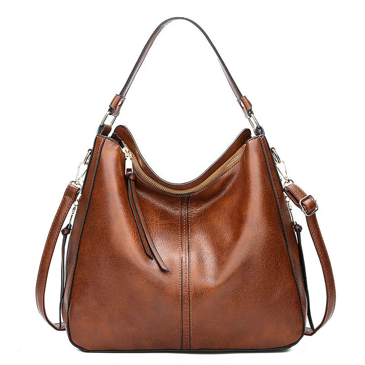Durable women's leather crossbody bag, built for daily essentials, featuring stylish gold hardware.