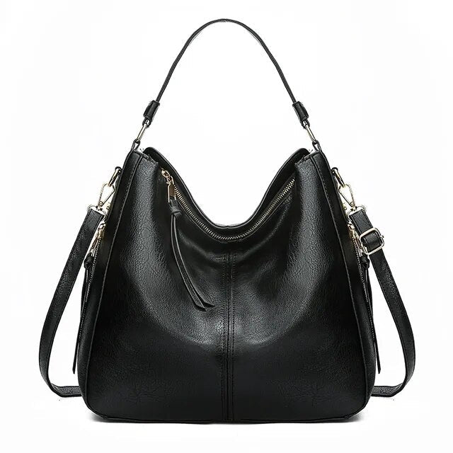 Compact yet organized women's leather shoulder bag with elegant gold details, perfect for essentials.