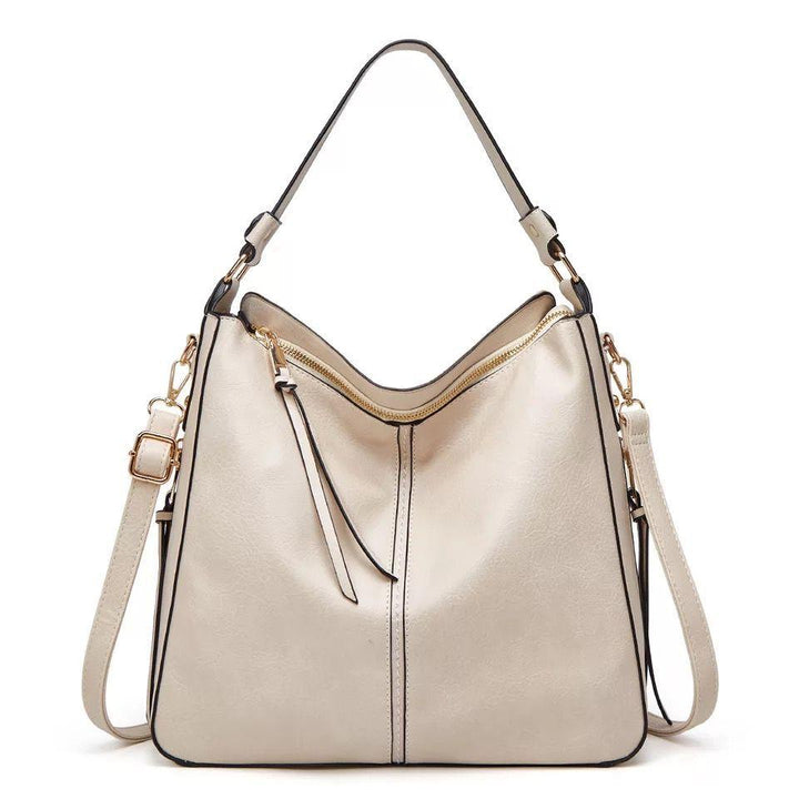 Organized women's leather crossbody bag, premium quality, featuring sleek design & gold accents.