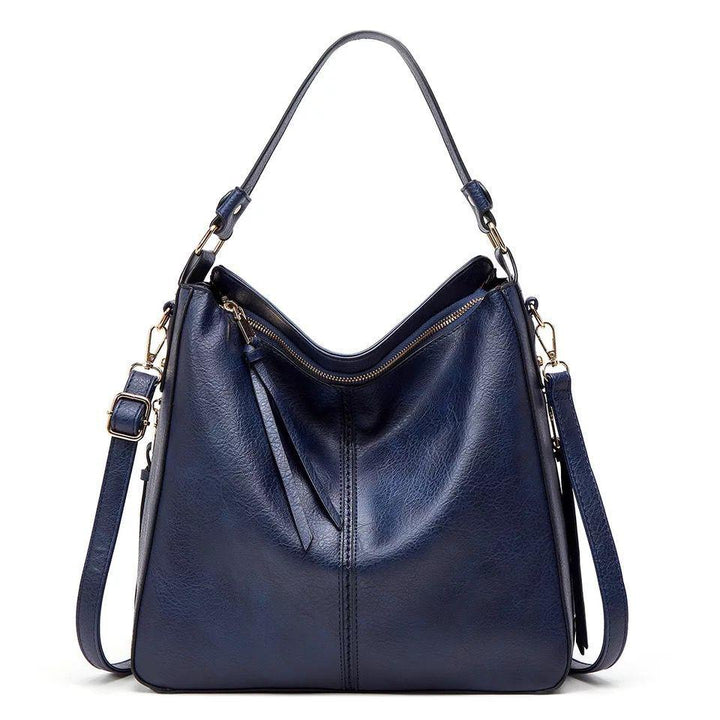 Versatile women's leather travel bag, elegant and organized, highlighted by stunning gold details.