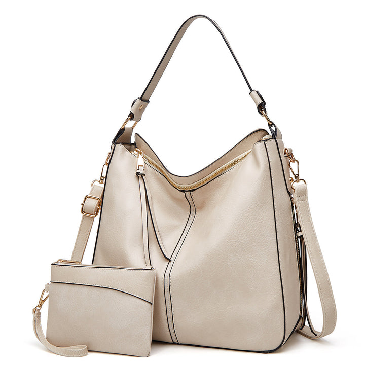 Chic women's leather crossbody bag, perfect for hands-free convenience & styled with gold hardware.