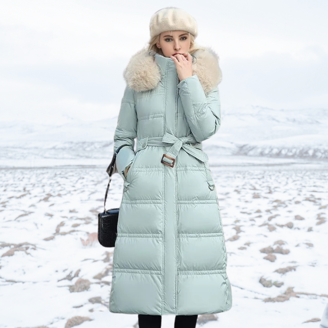 Stylish women's long puffer coat, equipped with a luxurious faux fur hooded collar for winter protection.