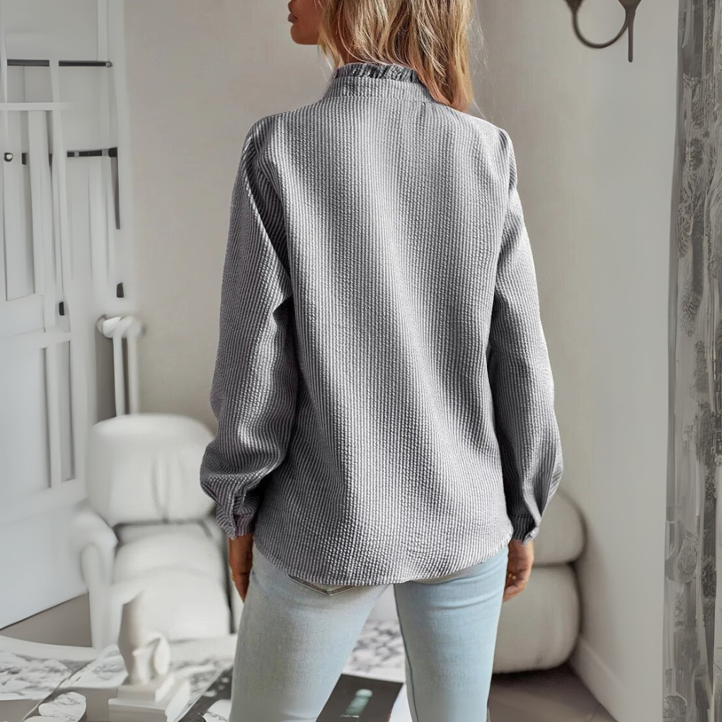 Women's elegant long-sleeve blouse. Sophisticated tie-neck top with puff sleeves for stylish workwear.