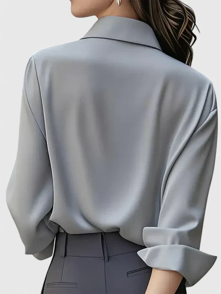 Fashionable women's button-down, a versatile long-sleeve top that transitions from office to casual easily.