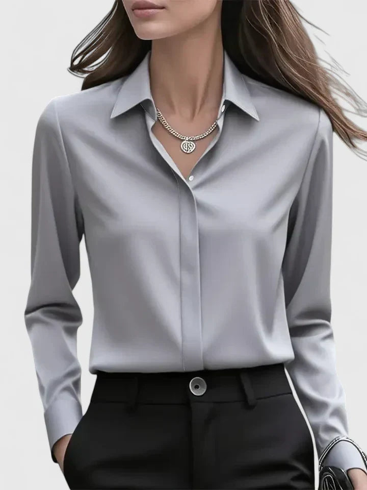 Detailed buttons on a women's versatile button-down top, a sophisticated long-sleeve blouse for any occasion.