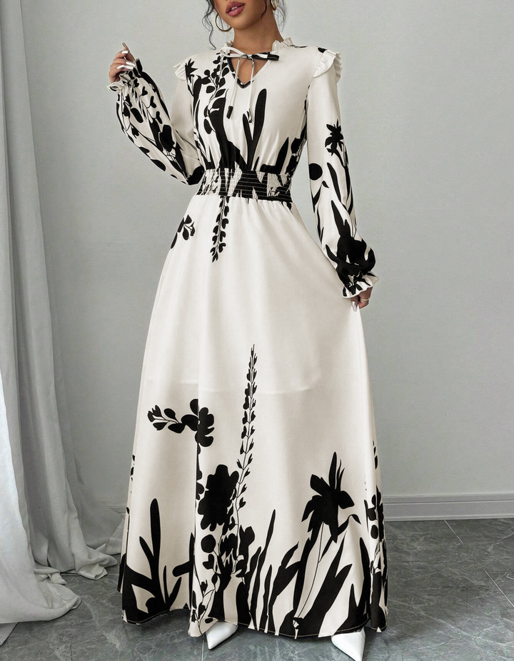 Close-up of elegant women's floral A-line dress, showcasing delicate print and long sleeves. Versatile midi length.
