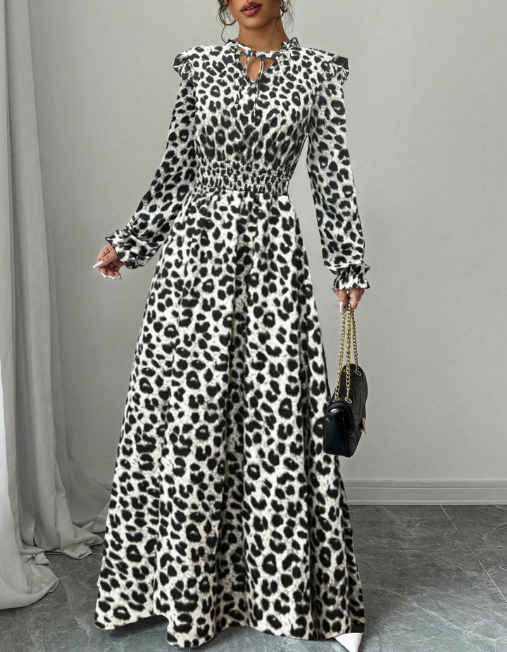 Woman wearing an elegant long sleeve floral A-line midi dress, styled for a versatile spring or summer occasion.
