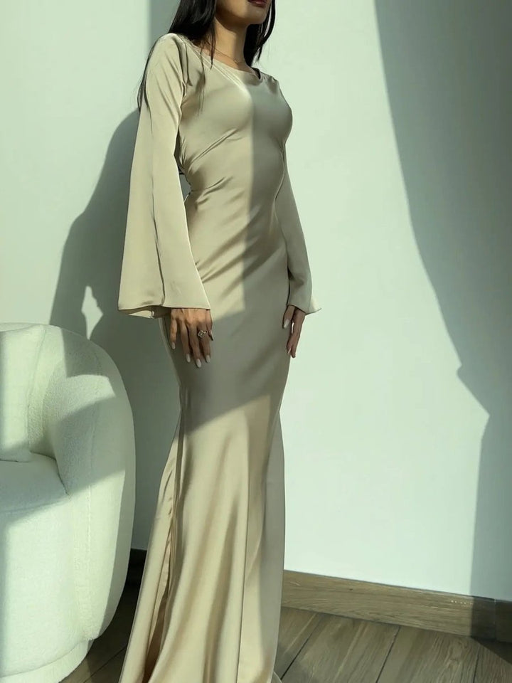 Black versatile long sleeve maxi dress, suitable for formal or evening wear.