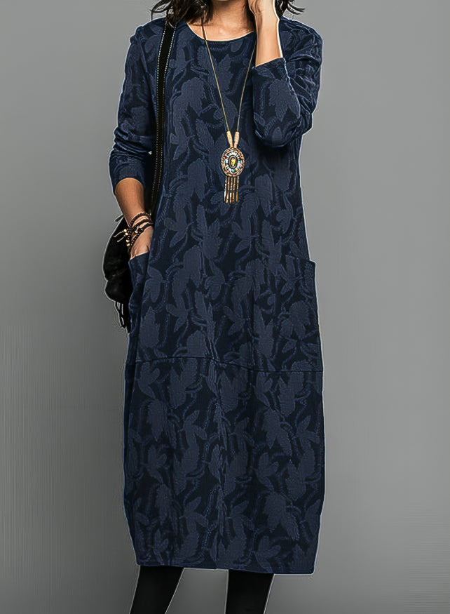 Full-length view of a women's elegant long-sleeve maxi dress, showcasing its versatile, flowing silhouette.