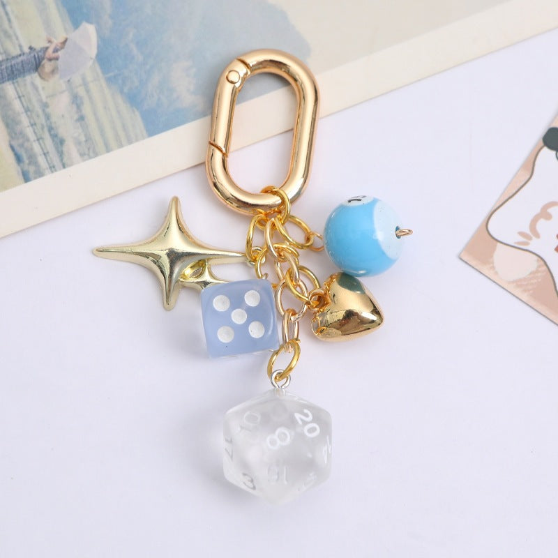 Colorful lucky charm keychain for women, metal construction with dice & bead accents, an elegant key & bag accessory.