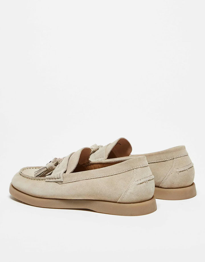 Sophisticated women's slip-on tassel loafers. New luxury footwear, perfect for dressy or casual outfits.