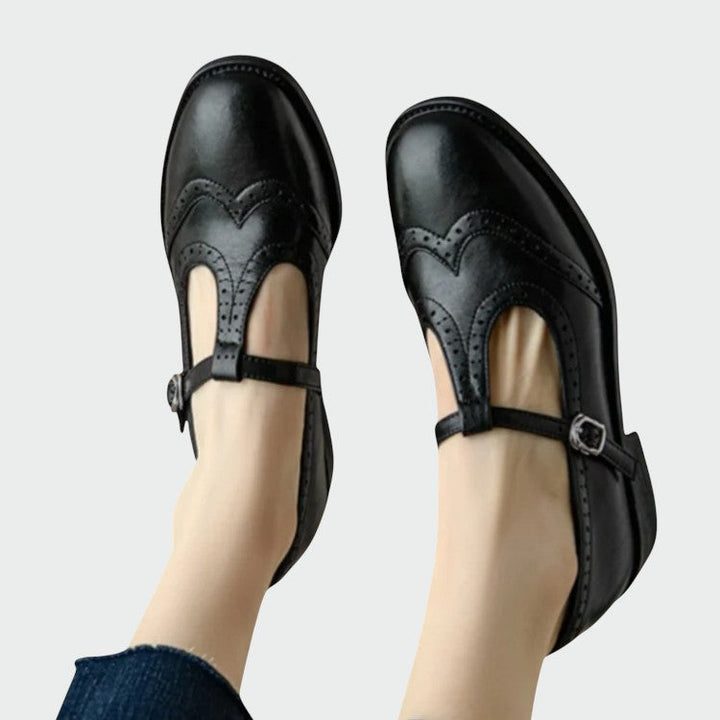 Vintage-inspired Mary Jane T-Bar shoes for women, featuring elegant brogue detail and comfort.