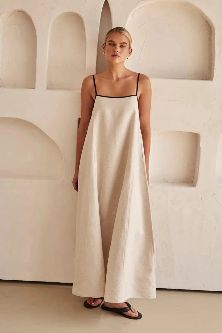 Casual yet elegant women's long summer dress with adjustable straps and a distinctive contrast trim detail.