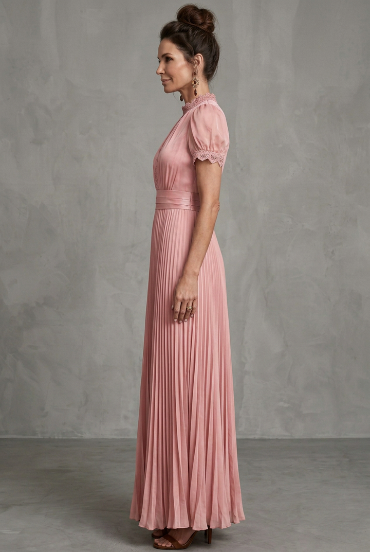 Formal women's evening gown with intricate lace trim and elegant pleats, suitable for special occasions.
