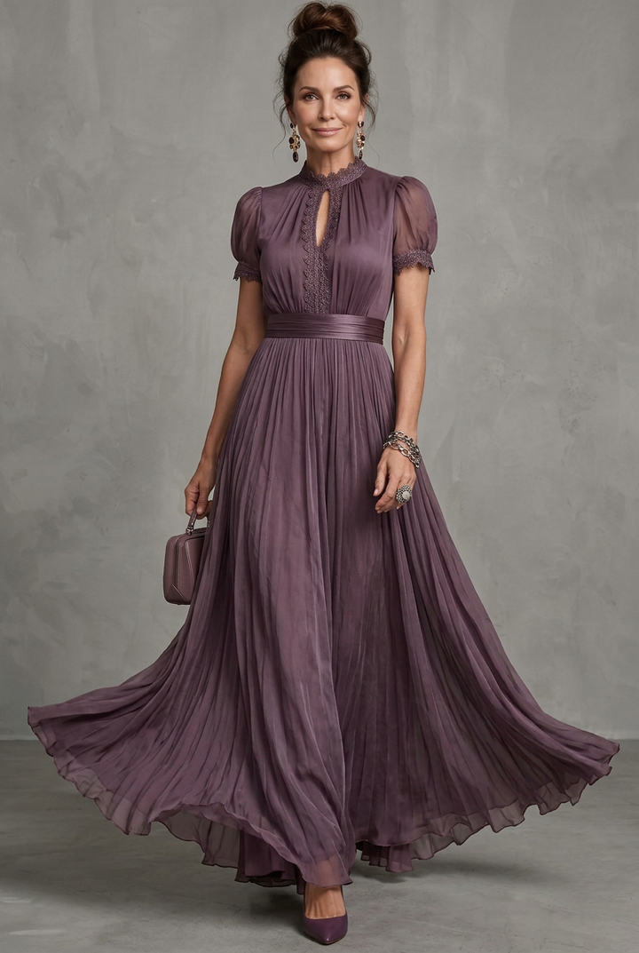 Sophisticated women's wedding guest dress, a lace-trim pleated maxi with elegant puff sleeves.