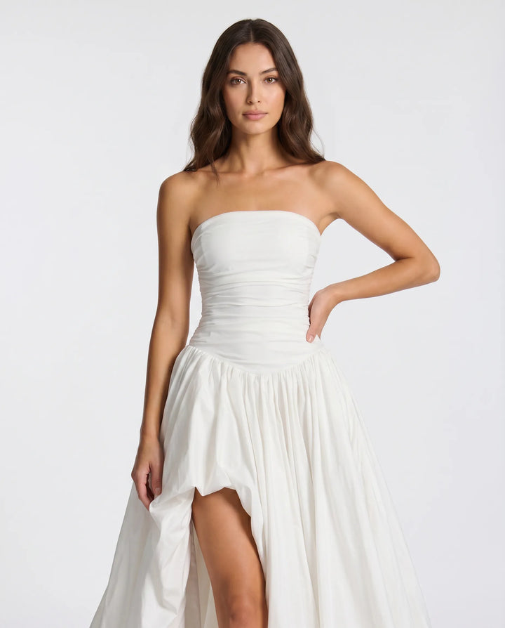 Woman posing in a beautiful elegant long dress, a perfect formal gown for any special event.