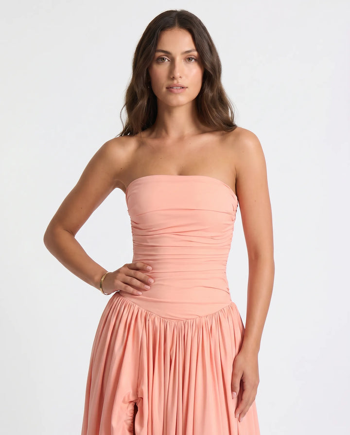 Side profile of a graceful women's long evening dress, showcasing its elegant design & feminine silhouette.