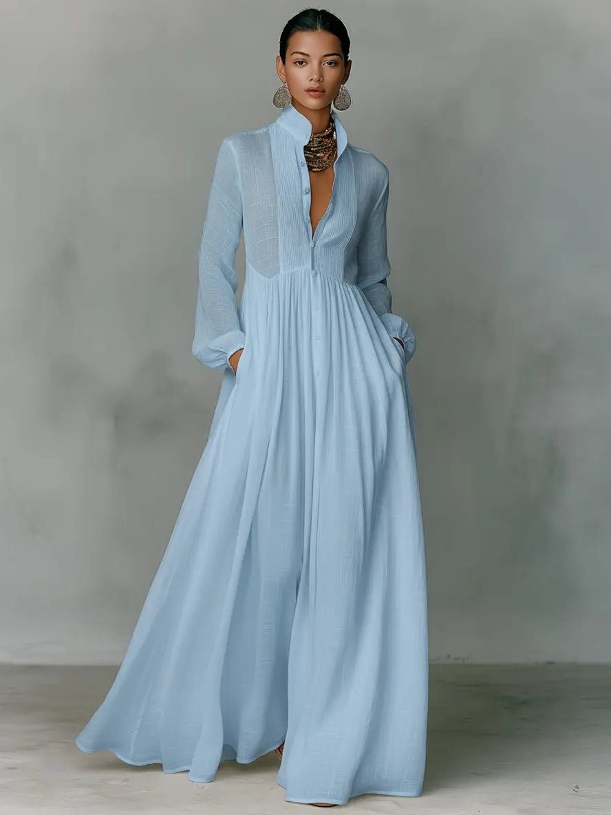 Full-length women's versatile maxi shirt dress with sophisticated stand collar, button-front, and practical pockets.