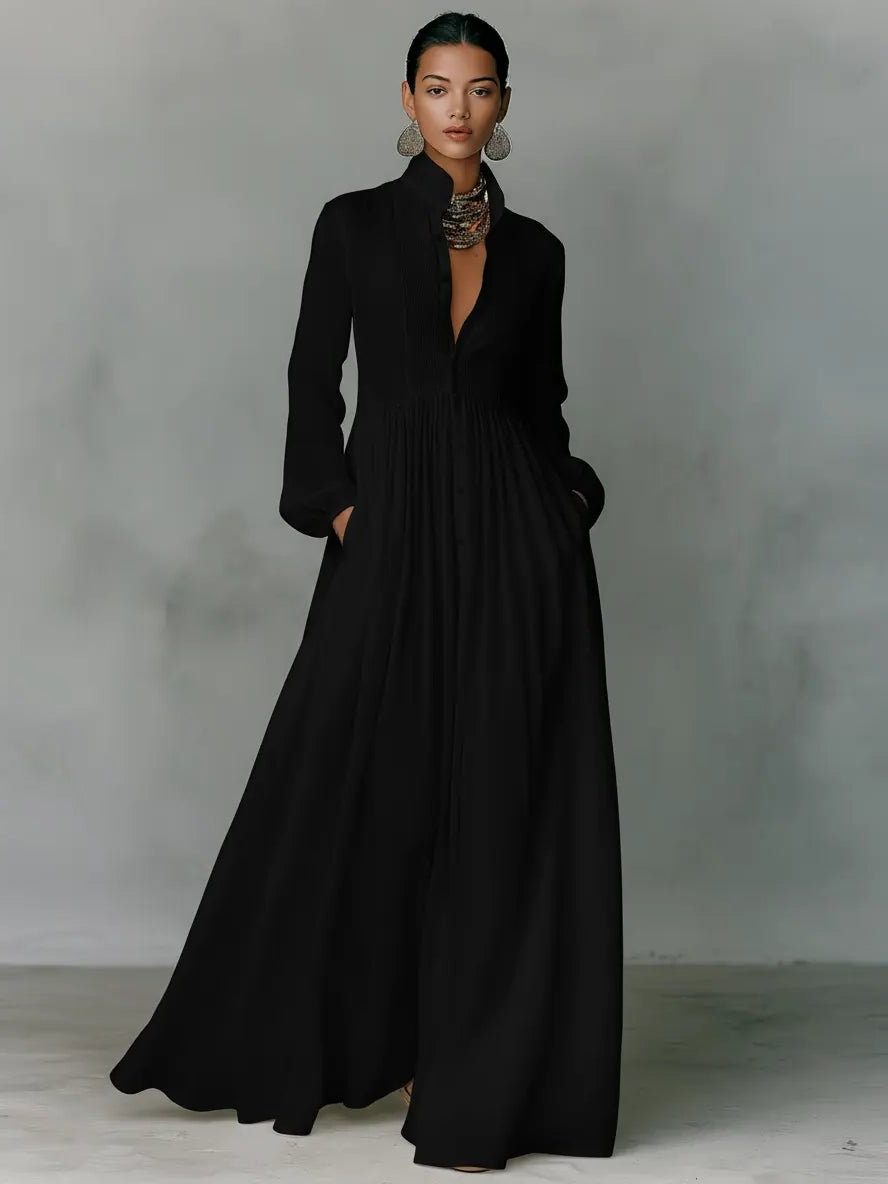 Close-up of a women's elegant long shirt dress, highlighting fabric texture, stand collar, and button details.