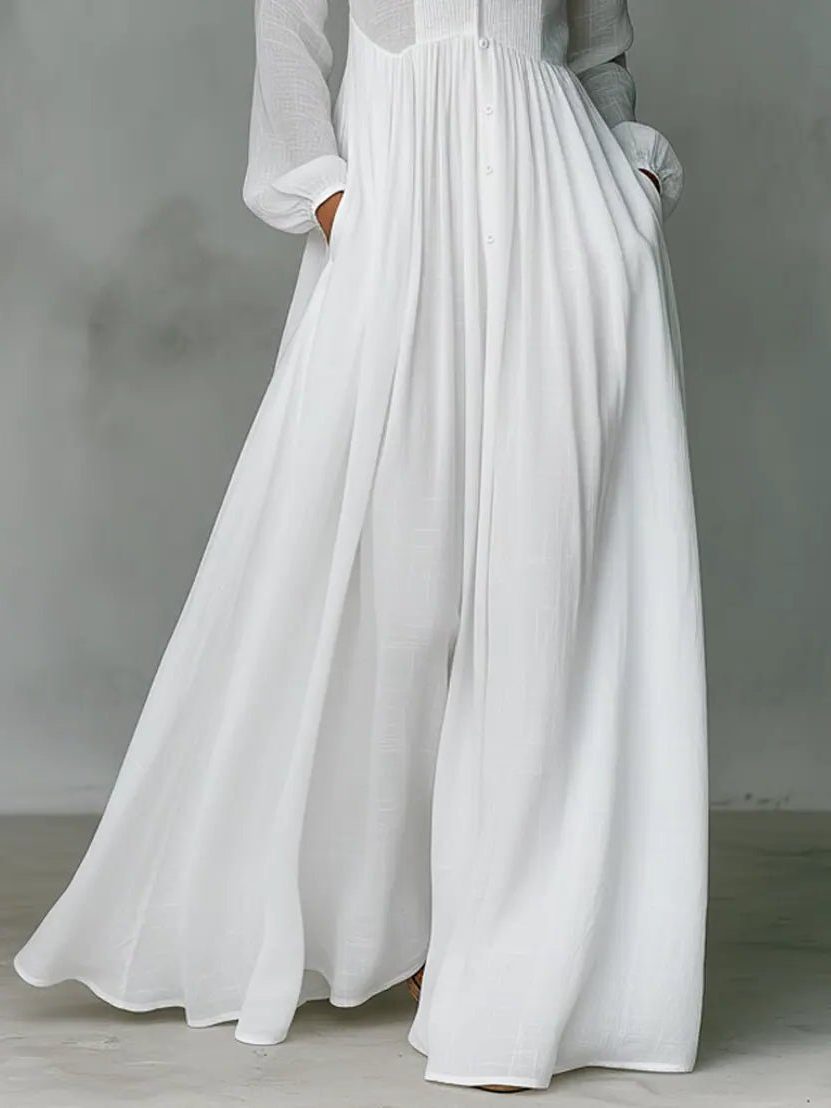 Detail shot of the stand collar and functional pockets on an elegant women's long button-front maxi shirt dress.