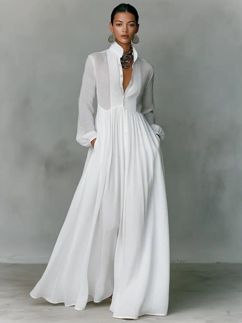 Stylish women's long shirt dress with stand collar, button-front, and pockets, perfect for elegant day-to-night wear.