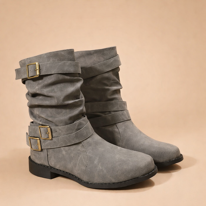 Mid-calf women's fashion boots with a sophisticated buckle, ideal elegant footwear for winter.