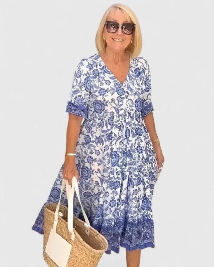 Elegant women's midi dress with a flattering fit, v-neck, and half sleeves, perfect for summer parties. Blue color.