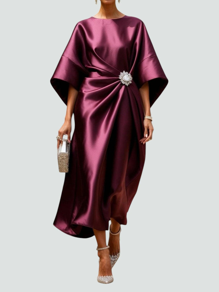 Women's draped midi dress featuring elegant kimono sleeves, a flattering gather waist, and a chic brooch detail.