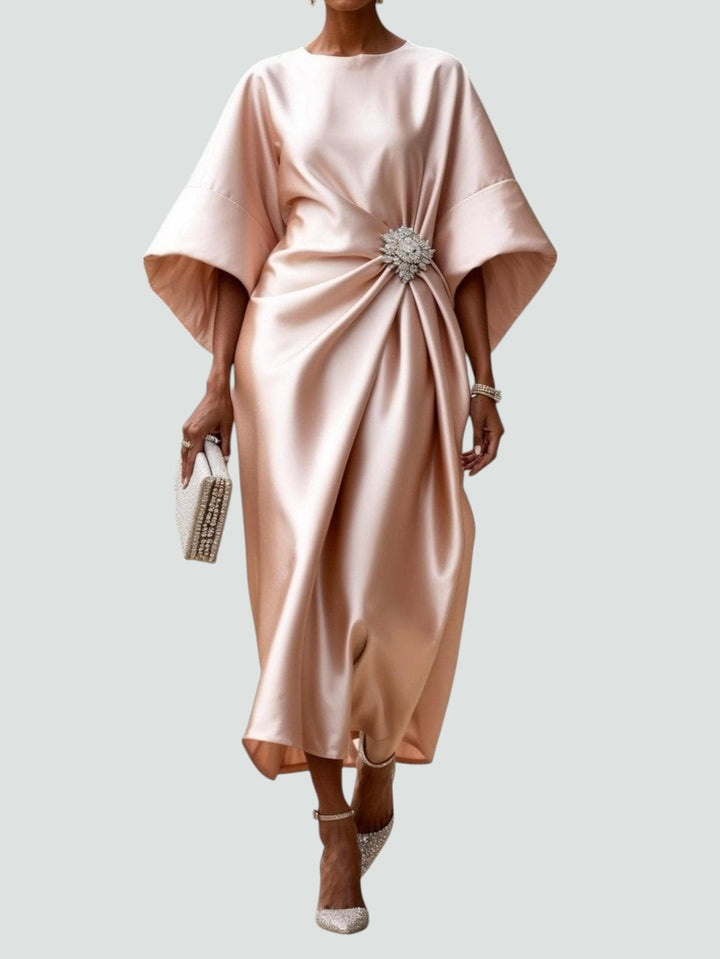 Stylish women's midi dress with a striking brooch accent, draped design, gather waist, suitable for elegant events.