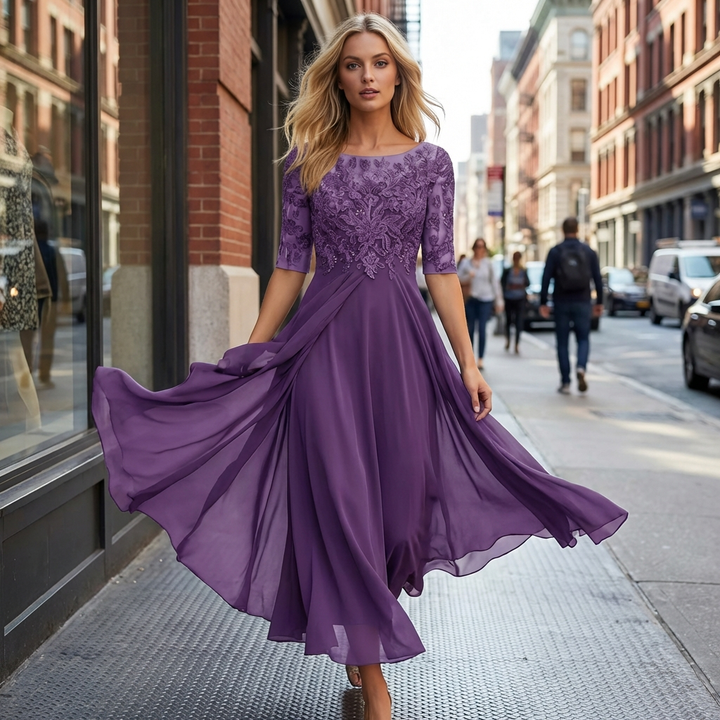 Sophisticated women's lace midi dress with a flowing skirt & three-quarter sleeves. Ideal wedding guest attire.