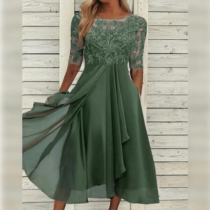 Chic women's party midi dress featuring a lace bodice, round neck & elegant flowing skirt. Perfect for celebrations.