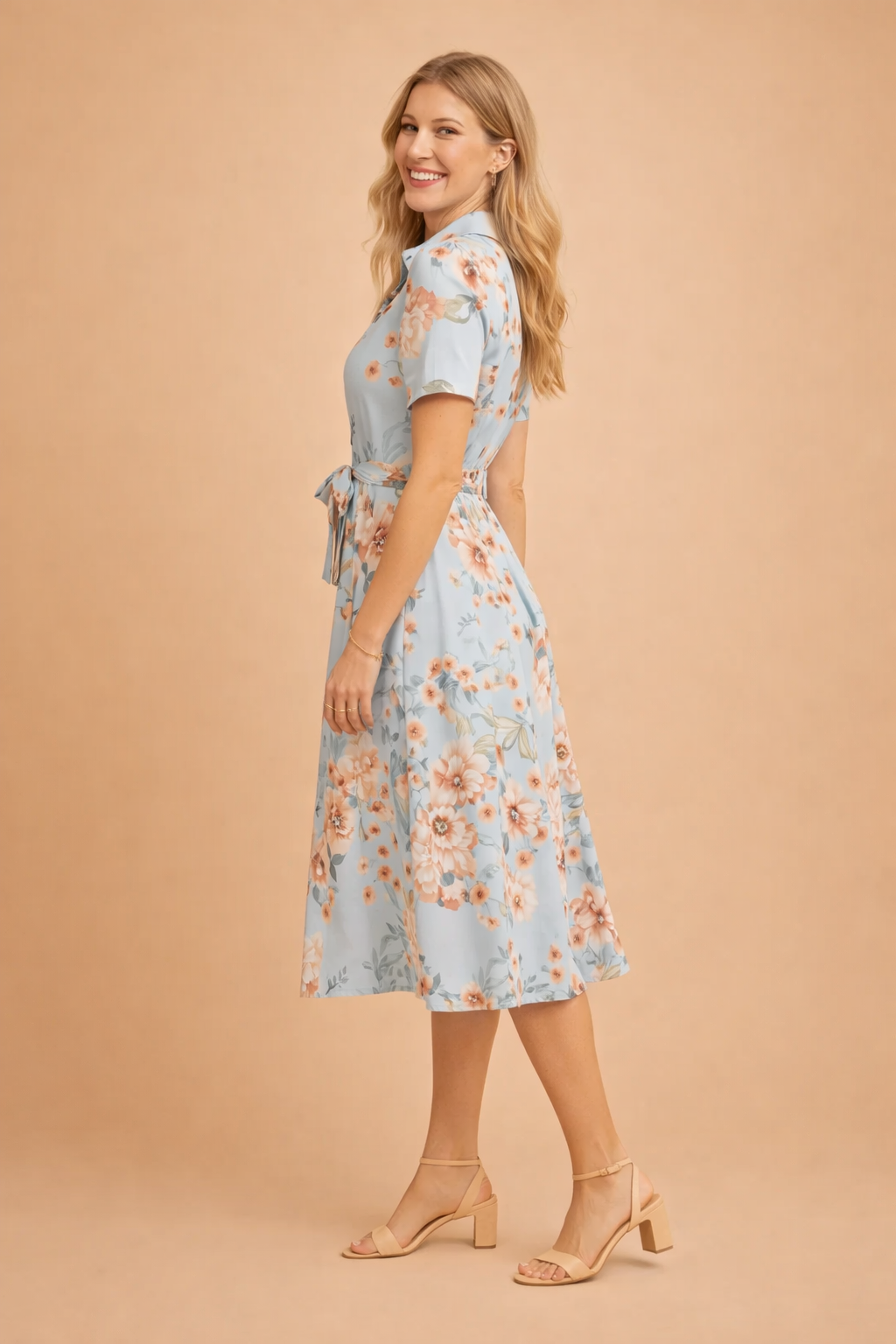 Woman confidently walking in an elegant midi shirt dress with a flattering belt & flowing side slit.