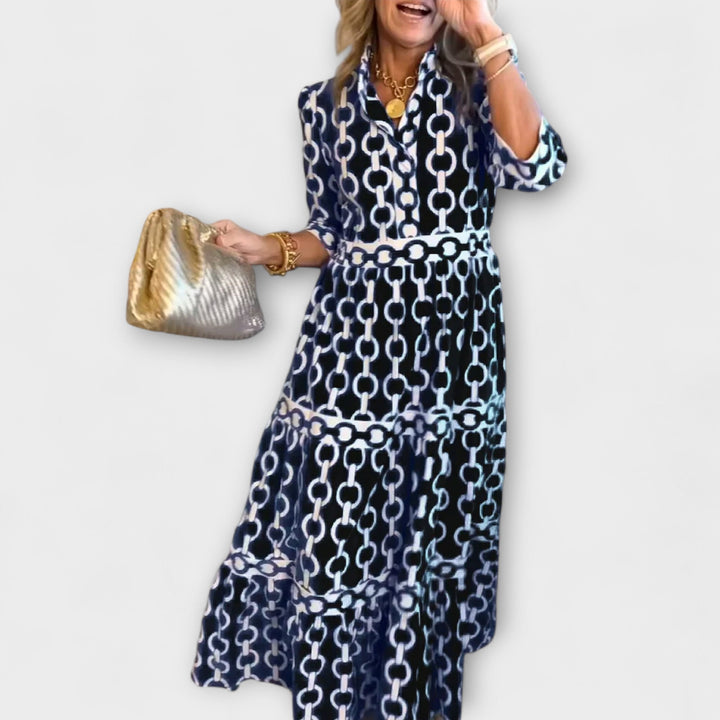 Close-up of the elegant chain pattern on a women's midi summer dress with a flattering tiered skirt.