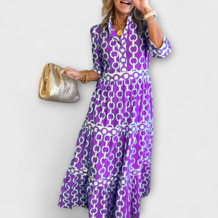 Women's comfortable midi dress with elegant chain pattern, flattering tiered skirt & three-quarter sleeves for summer.