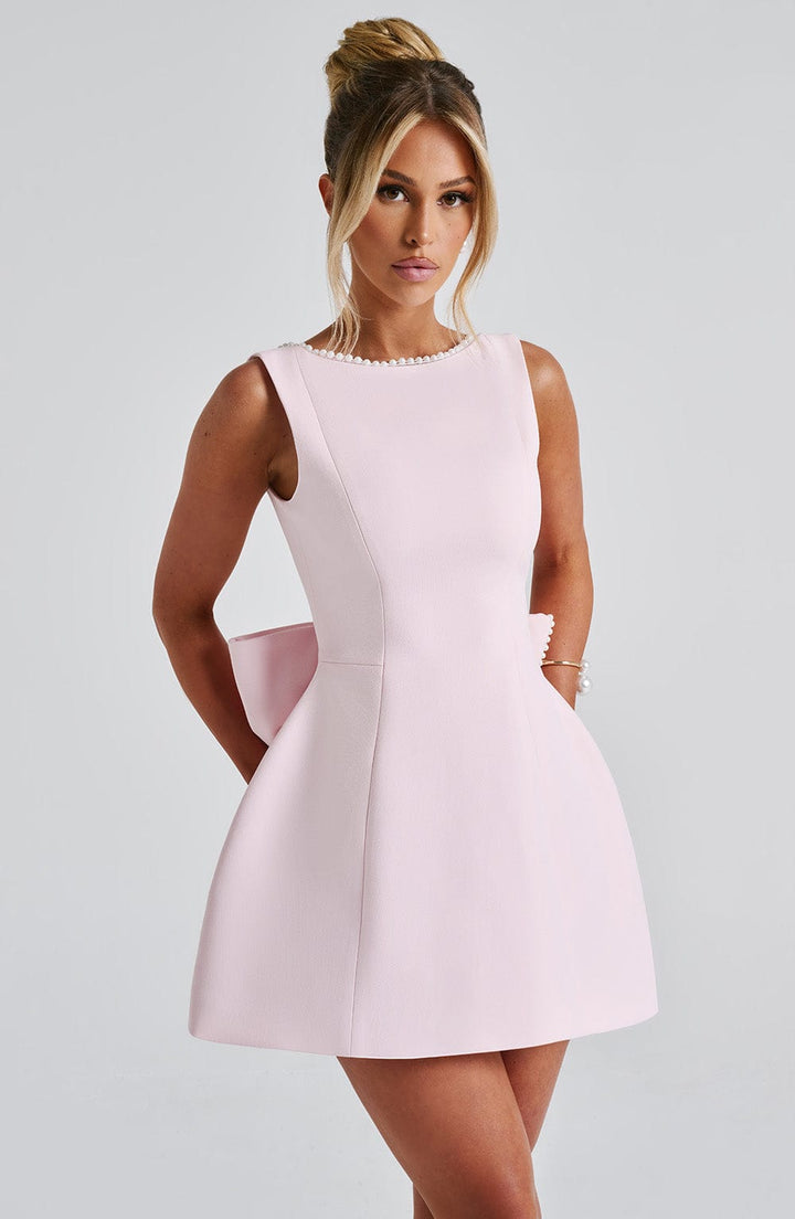 Gorgeous women's cocktail mini dress, pearl-trimmed, with an eye-catching bow detail at the back.