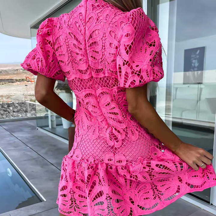 Women's slim-fit cocktail dress featuring a modern cut-out and delicate ruffles. Ideal for evening events.