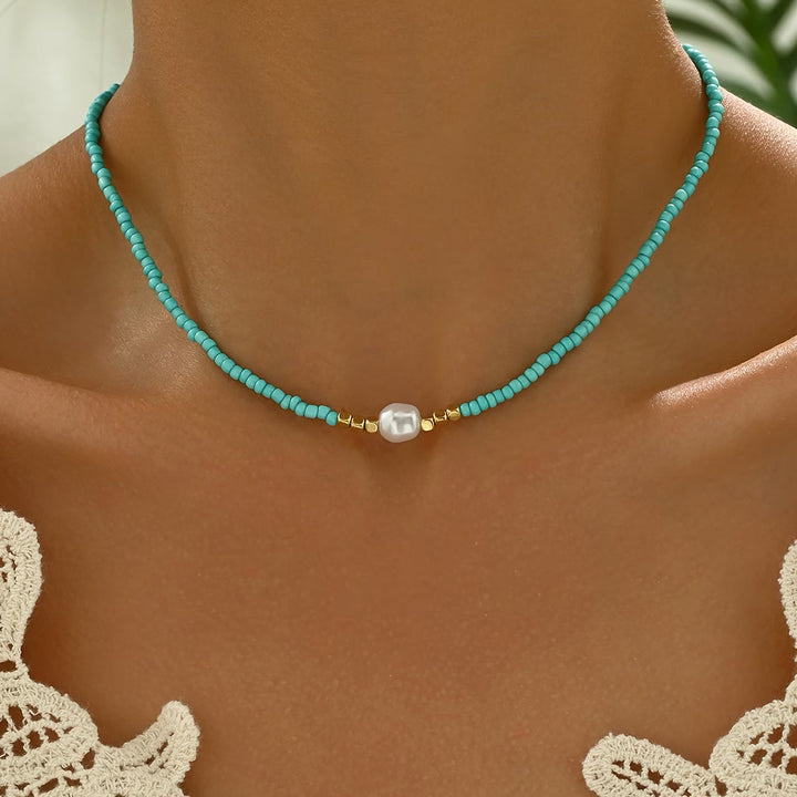 Elegant women's minimalist necklace with a single white pearl and a small turquoise bead. Perfect jewelry gift.