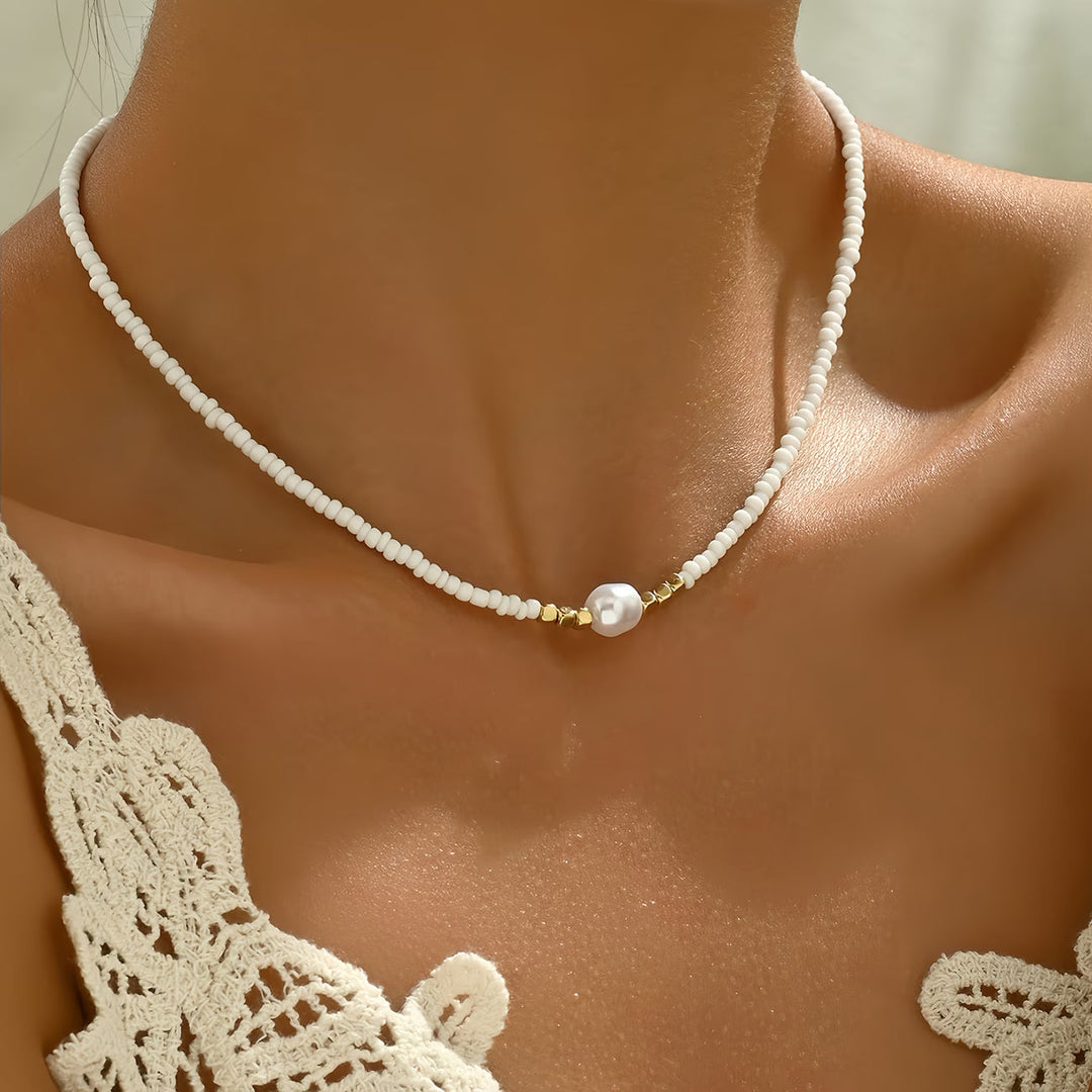 Beautiful minimalist women's necklace with a luminous white pearl and a striking turquoise accent. Elegant gift.