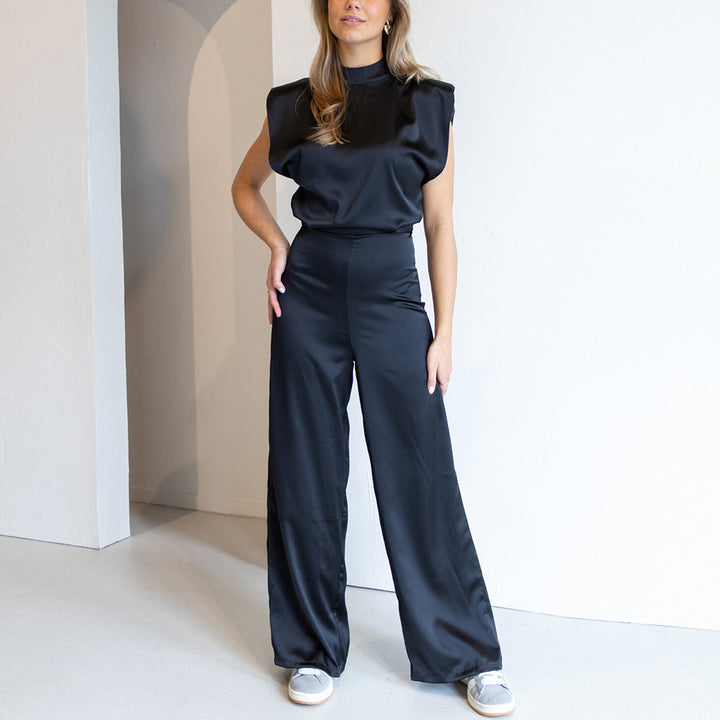 Stylish women's wide leg formal jumpsuit, features a mock neck and sleeveless cut for elegant evening style.