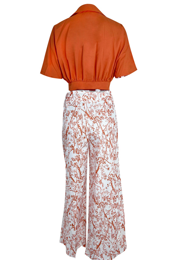 Chic women's crop top with puff sleeves, paired with flowy palazzo pants; perfect for a modern vacation look.