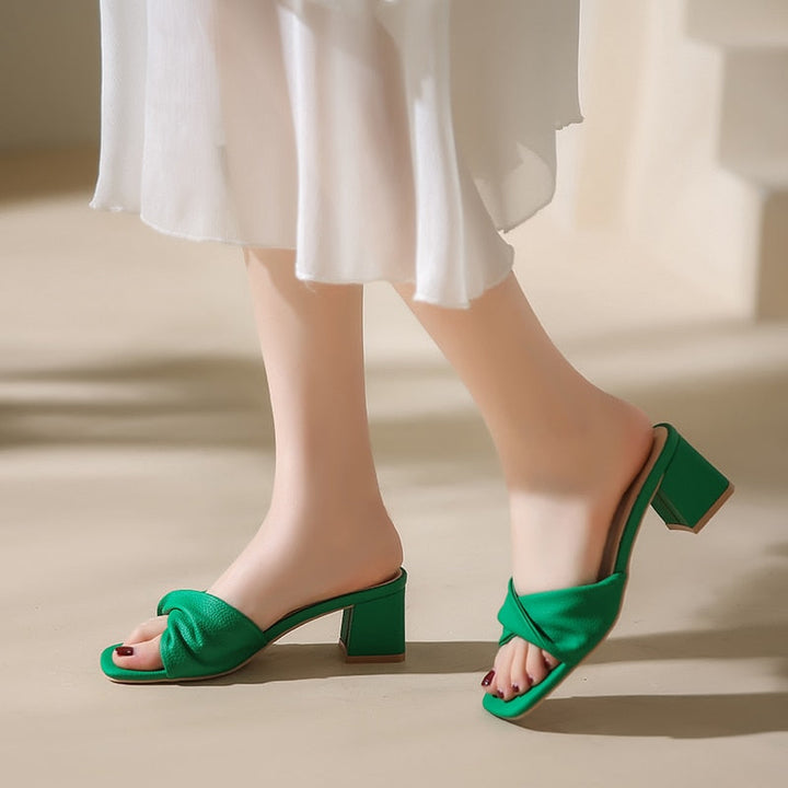 Elegant women's mule sandals with twisted strap, block heel, open toe. Perfect slip-on heels for summer.