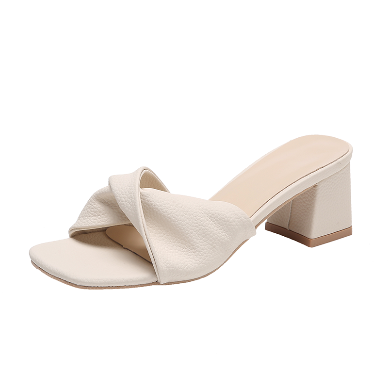 Open-toe women's block heel mule sandals featuring a chic twisted strap. Dressy slip-on heels for elegant comfort.