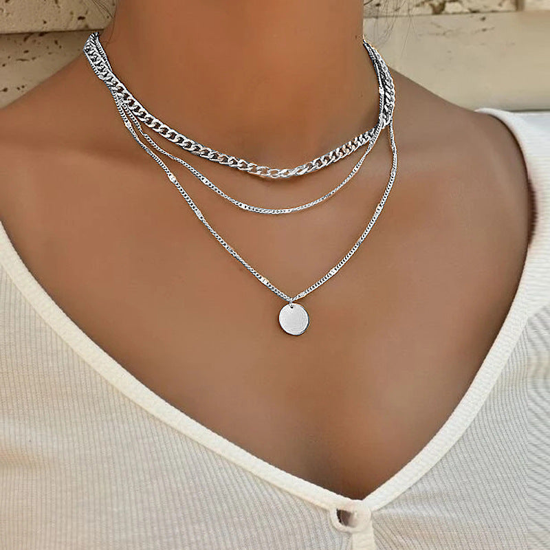 Stylish women's multi-layered chain necklace, showcasing delicate chains in chic gold. Perfect fashion accessory.