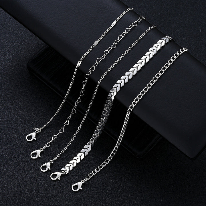 Women's layered gold chain bracelet set elegantly styled on a wrist, enhancing any outfit with a chic touch.