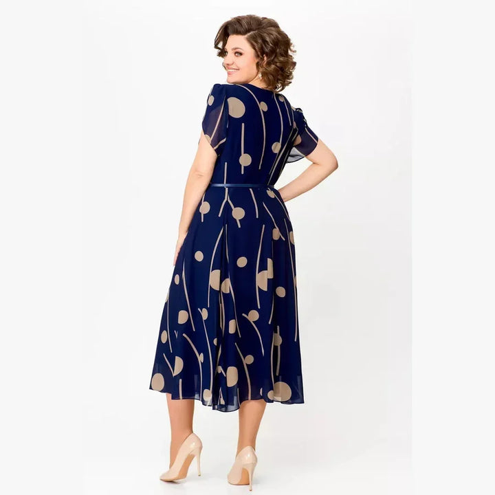 Comfortable navy polka dot midi dress for women. Classic, versatile style suitable for everyday wear or events.