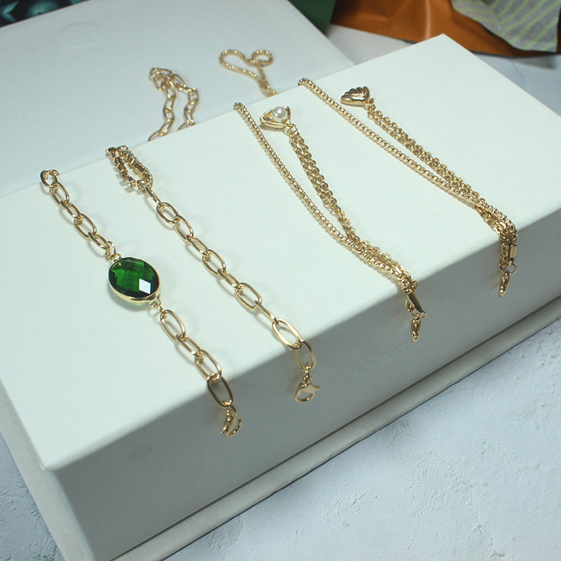 Close-up of an elegant green stone necklace for women, detailed with gold accents. A chic statement jewelry piece.