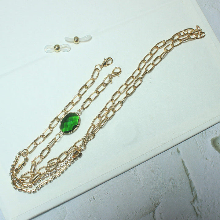 Fashionable women's jewelry: an elegant green stone necklace with intricate gold accents, perfect statement piece.