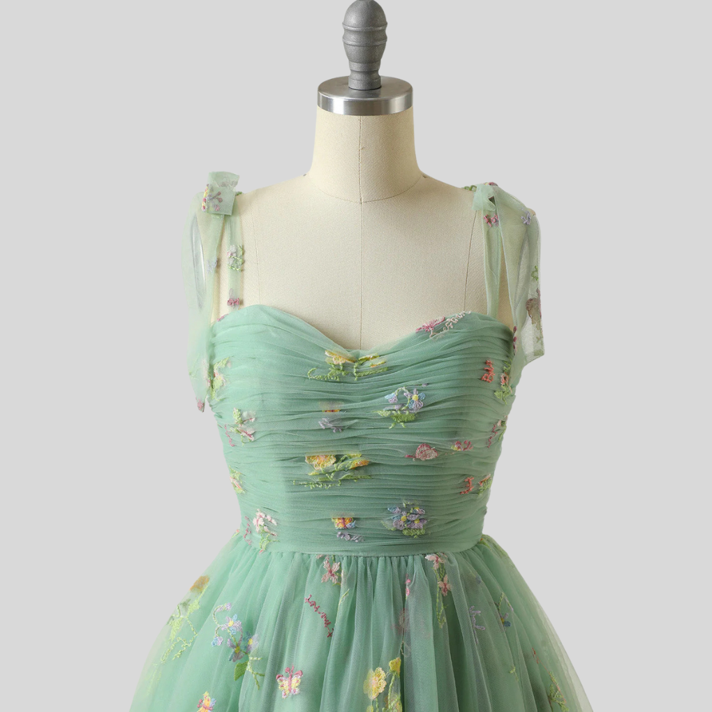 Elegant women's off-shoulder embroidered tulle ball gown for formal evening events.