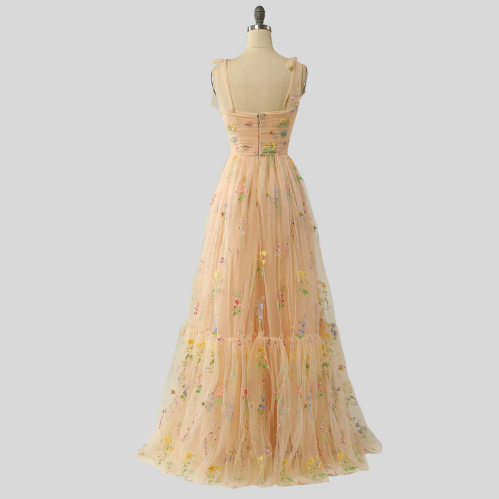Elegant women's evening wear: embroidered tulle ball gown, off-shoulder design, special occasion.
